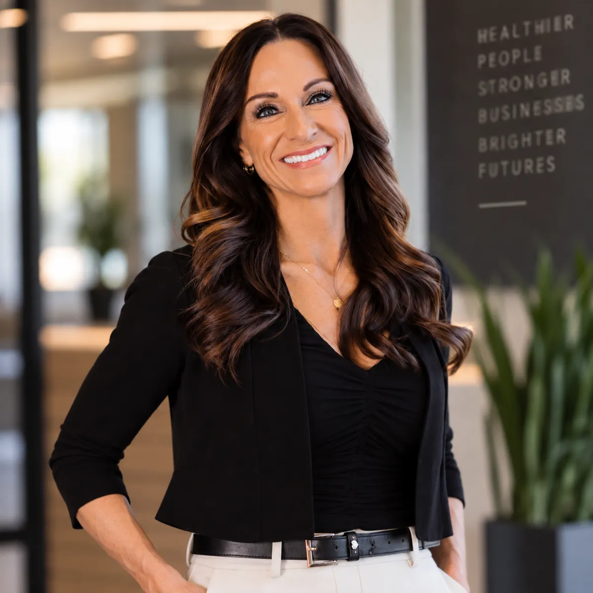 Jessica Harris, smiling, in a black blazer at the office